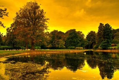 Scenic view of lake against sky at sunset