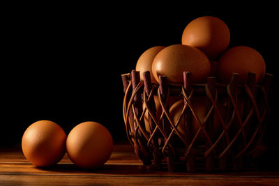 Close-up of eggs on table against black background