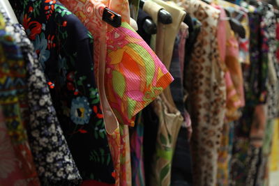 Close-up of clothes hanging in store for sale