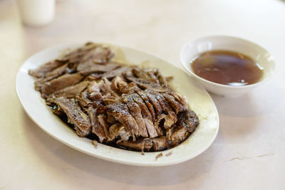 Close-up of braised duck served in plate on table