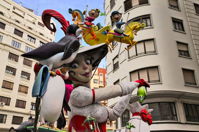 Low angle view of women standing by building