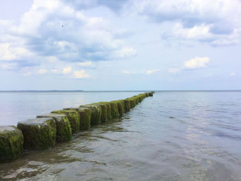 Scenic view of sea against cloudy sky