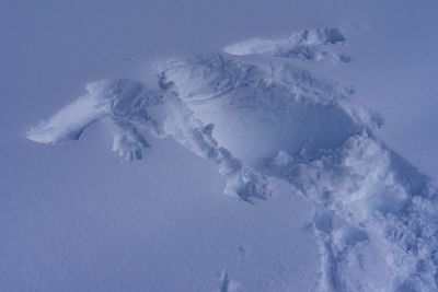 High angle view of snow covered land against sky