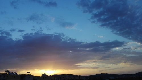 Silhouette buildings against sky during sunset