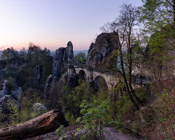 Old bridge and rock formations at sunrise