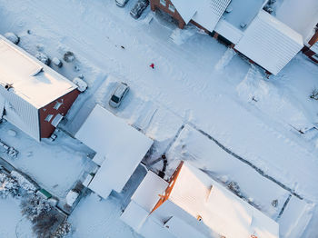 High angle view of buildings on snow covered field