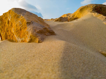 Surface level of sand dunes in desert against sky