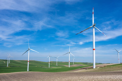 Wind turbines and green agricultural landscape seen in southern italy