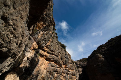 Low angle view of rock formations against sky