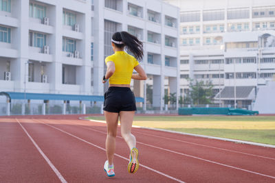 Rear view of woman running