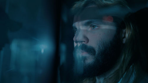 Close-up of a man behind a glass