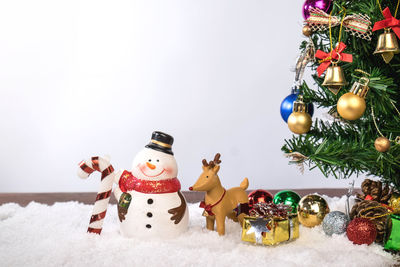 Close-up of christmas decorations against white background