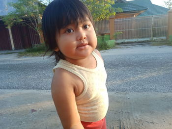 Portrait of cute girl standing outdoors