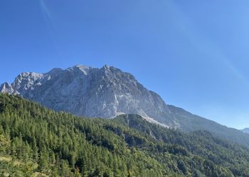 Scenic view of mountains against clear blue sky