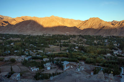 Scenic view of landscape and mountains against clear sky