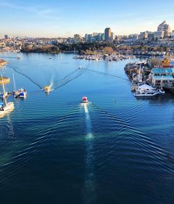 High angle view of sailboats sailing in sea against sky