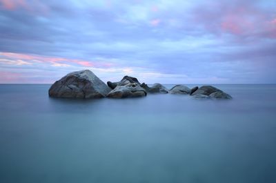 View of calm sea against cloudy sky