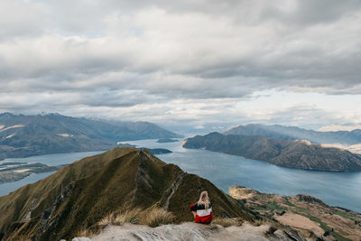 Rear view of woman standing on cliff