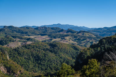 Scenic view of mountains against clear blue sky