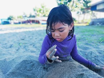 Cute girl playing with sand