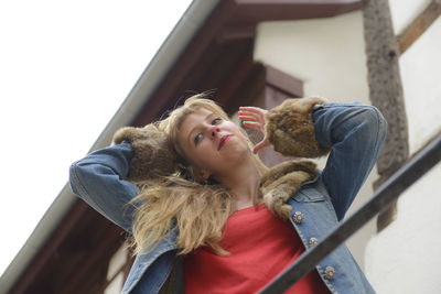 Low angle view of woman looking away