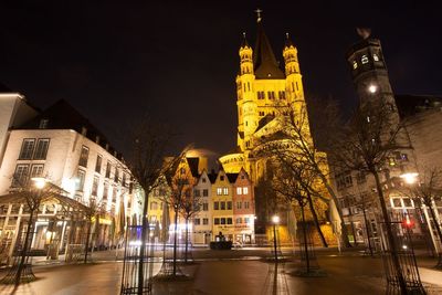 Low angle view of illuminated great st martin church against sky at night