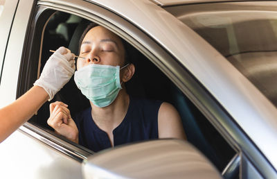 Midsection of man sitting in car