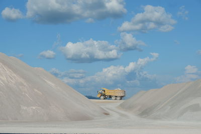 Scenic view of road amidst desert against sky