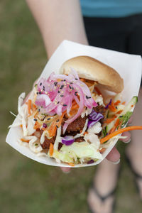 Close-up of hand holding food outdoors