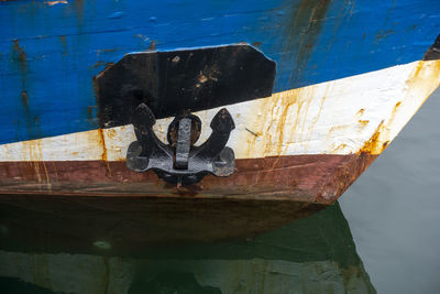 Close-up of rusty ship in water