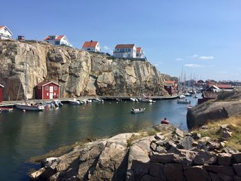 Scenic view of river by buildings against sky