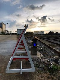 Rear view of man against sky at sunset