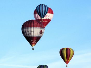 Low angle view of hot air balloon against clear blue sky