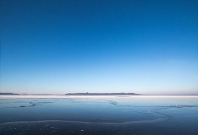 Scenic view of beach against blue sky