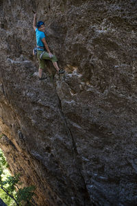 Low angle view of person on rock