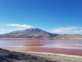 Scenic view of mountain against red lake in national park of bolivia