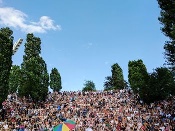 Audience at mauerpark against sky