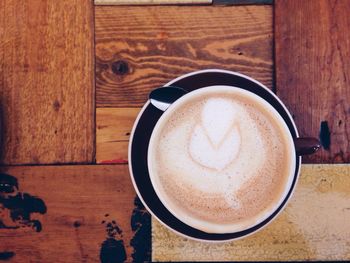 Directly above shot of coffee cup on wooden table