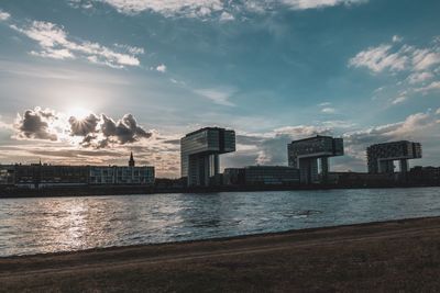 River by buildings against sky in city