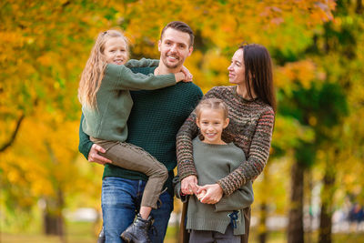 Full length of a smiling young woman in autumn