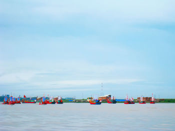 Boats in sea against sky