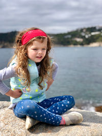 Cute girl sitting outdoors