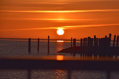 Scenic view of sea against orange sky during sunset