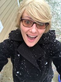 Portrait of smiling woman standing in snow