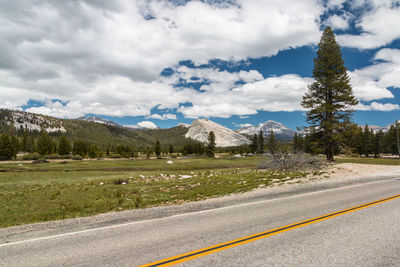 Empty road with mountain range in background
