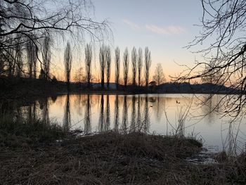 Scenic view of lake against sky during sunset