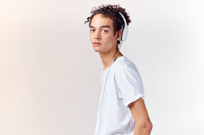 Portrait of teenage girl standing against white background