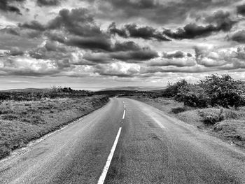 Road passing through landscape against sky