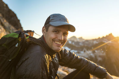 Portrait of backpacker smiling, enjoying night in the mountains.