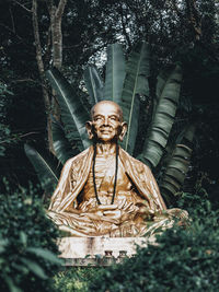 Low angle view of statue against trees in park